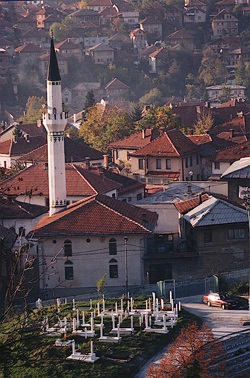 Photo of Sarajevo, with minaret and graves in foreground, photo by author.